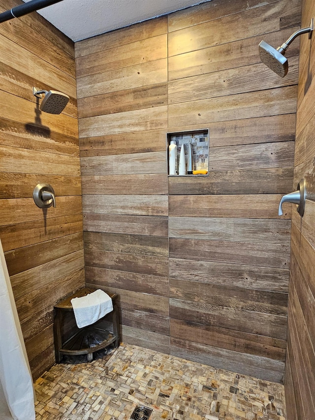 bathroom featuring walk in shower and wood walls