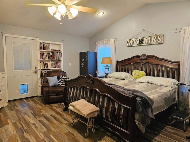 bedroom with ceiling fan, dark wood-type flooring, and lofted ceiling