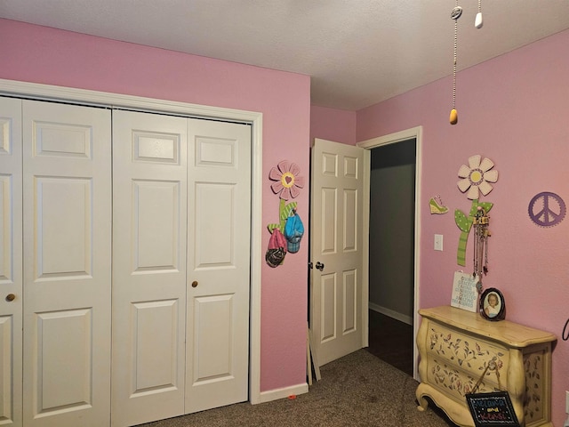 bedroom featuring a closet and dark carpet