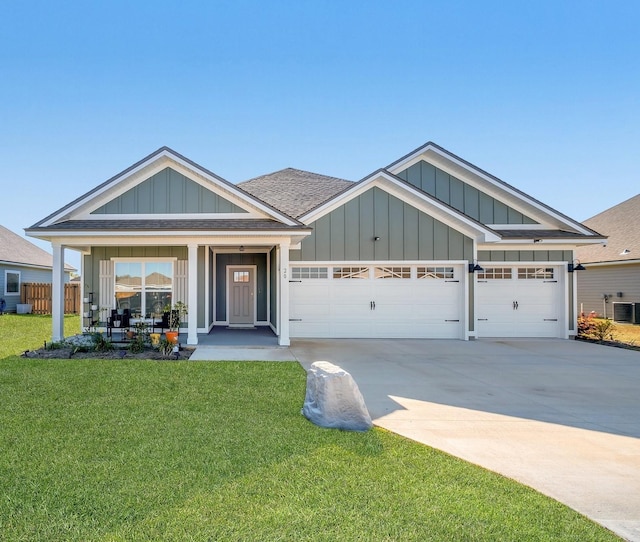 view of front of property with driveway, a front yard, central air condition unit, an attached garage, and board and batten siding