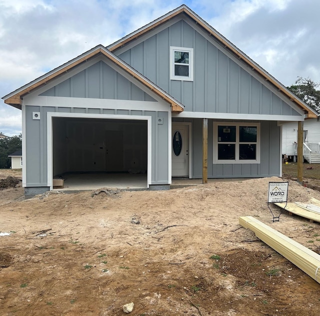 view of front facade with board and batten siding and a garage