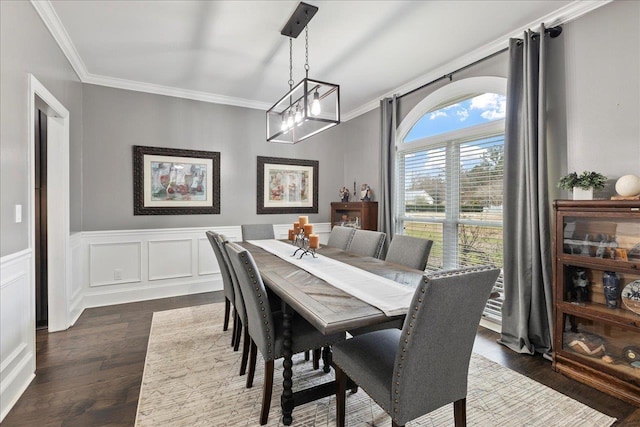 dining area featuring ornamental molding and dark hardwood / wood-style flooring