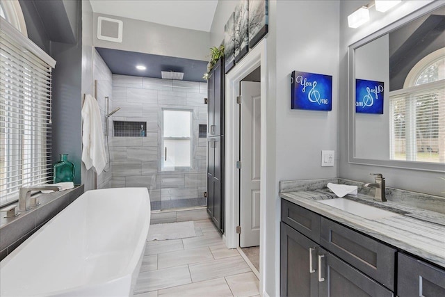 bathroom featuring vanity, tile patterned floors, and a shower with shower door