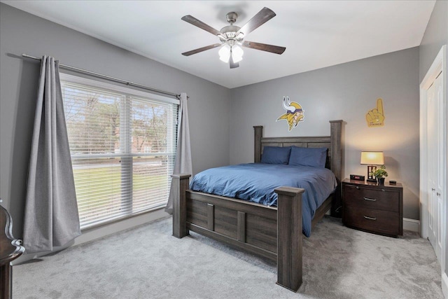 bedroom with light carpet and ceiling fan