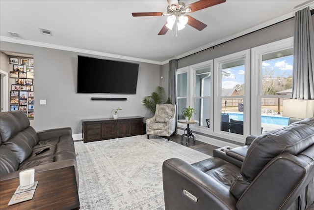 living room featuring crown molding, wood-type flooring, and ceiling fan