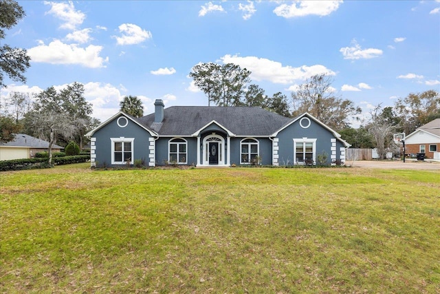 ranch-style home featuring a front yard