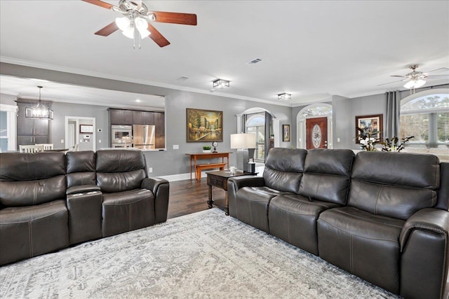 living room featuring ceiling fan, ornamental molding, and hardwood / wood-style floors