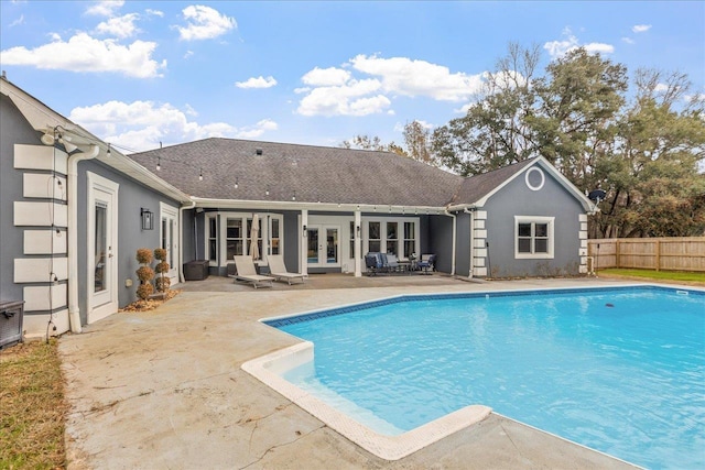 view of pool with an outbuilding, a patio area, and french doors