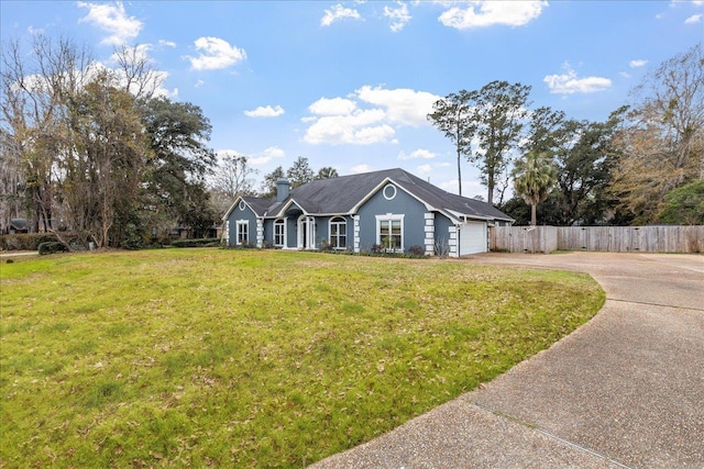 ranch-style house with a garage and a front lawn