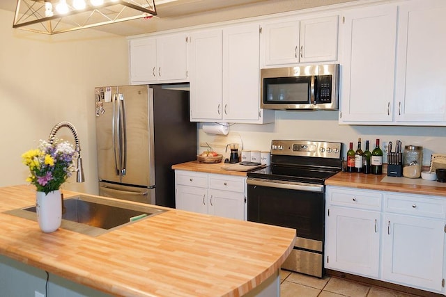 1839 Meriadoc Rd, Tallahassee, FL 32303 - kitchen with wooden counters, appliances with stainless steel finishes, white cabinetry, and light tile patterned floors
