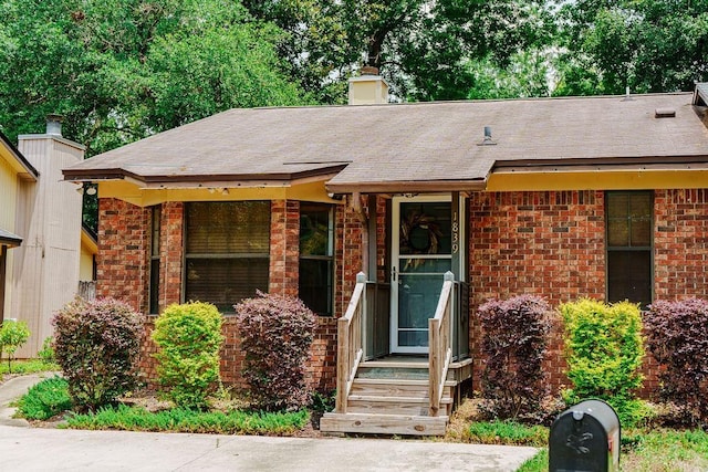 1839 Meriadoc Rd, Tallahassee, FL 32303 - view of front of property featuring brick siding, a chimney, and roof with shingles