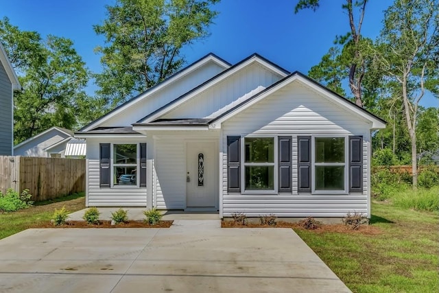 bungalow-style home with a front lawn