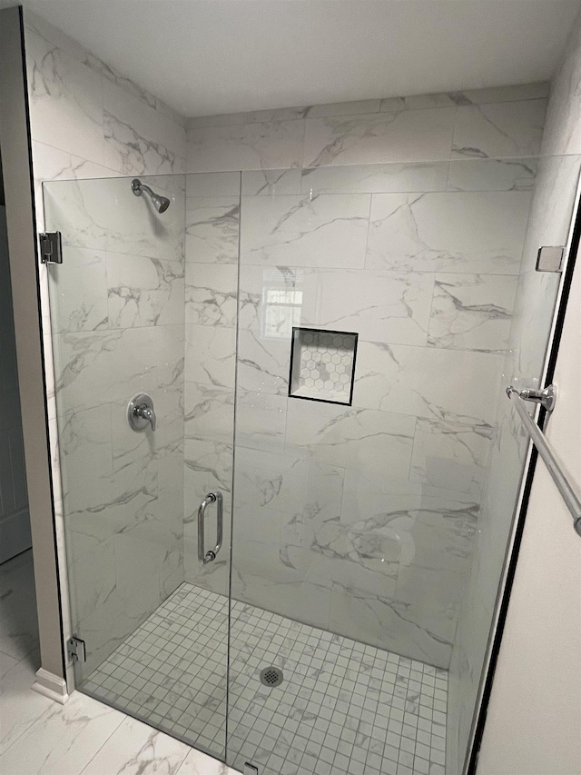 bathroom featuring a shower with door