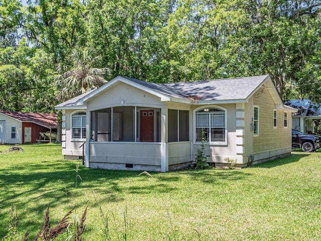 734 Port Leon Dr, Saint Marks, FL 32355 - view of front of house featuring crawl space, a sunroom, a front lawn, and a shingled roof