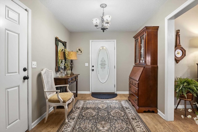 entryway with a notable chandelier and light wood-type flooring