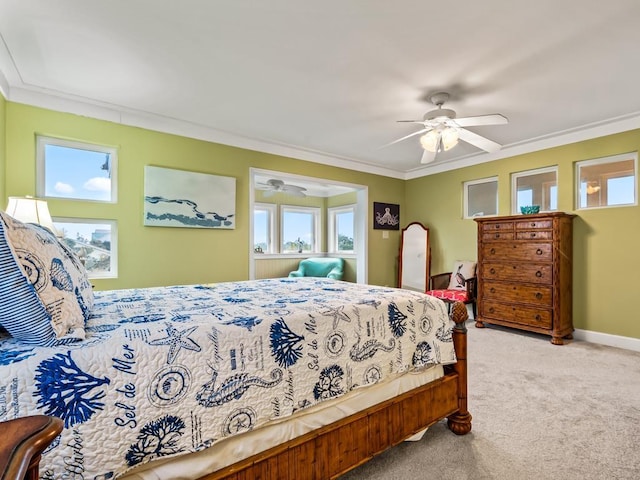 carpeted bedroom with ceiling fan and crown molding