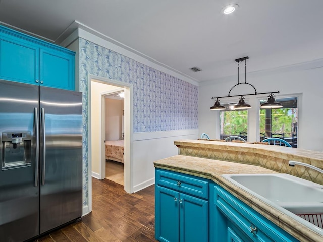 kitchen featuring stainless steel fridge with ice dispenser, blue cabinets, and dark wood-type flooring