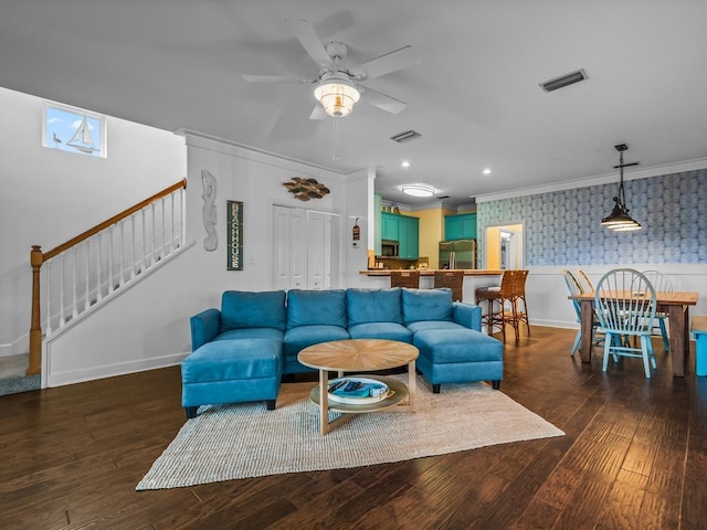 living room featuring ceiling fan, crown molding, and dark wood-type flooring