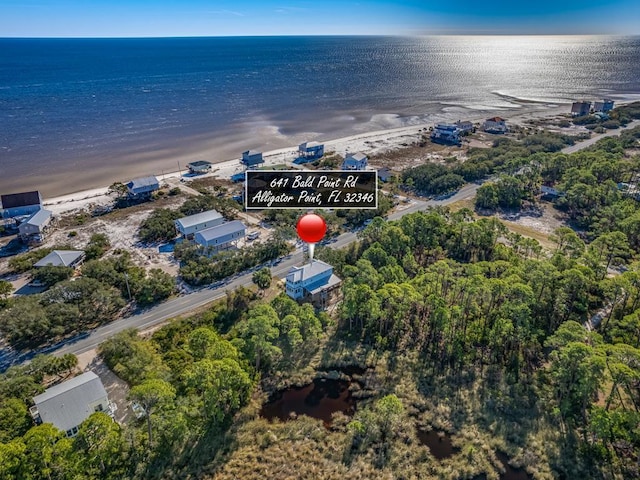 bird's eye view featuring a water view and a view of the beach