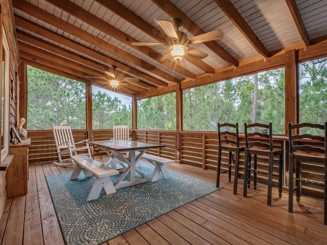 sunroom / solarium with vaulted ceiling with beams, a wealth of natural light, and wooden ceiling