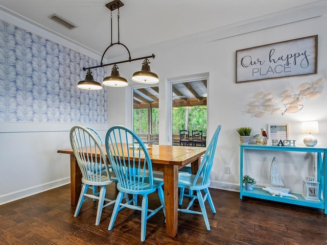 dining room featuring crown molding and dark hardwood / wood-style flooring