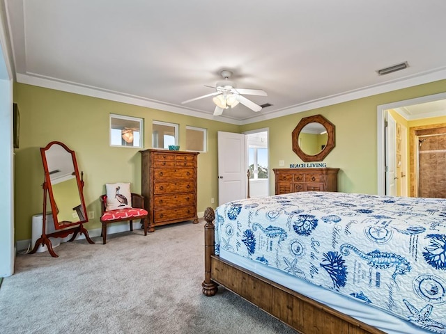 carpeted bedroom with ceiling fan and ornamental molding