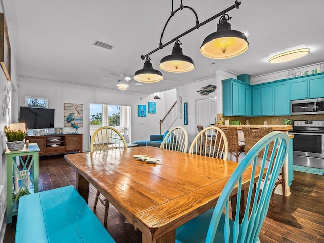 dining room featuring ceiling fan, dark hardwood / wood-style flooring, and ornamental molding