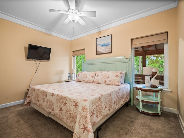 carpeted bedroom featuring ceiling fan and ornamental molding