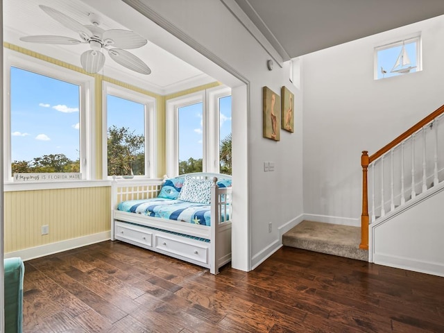 bedroom with dark hardwood / wood-style floors and ceiling fan