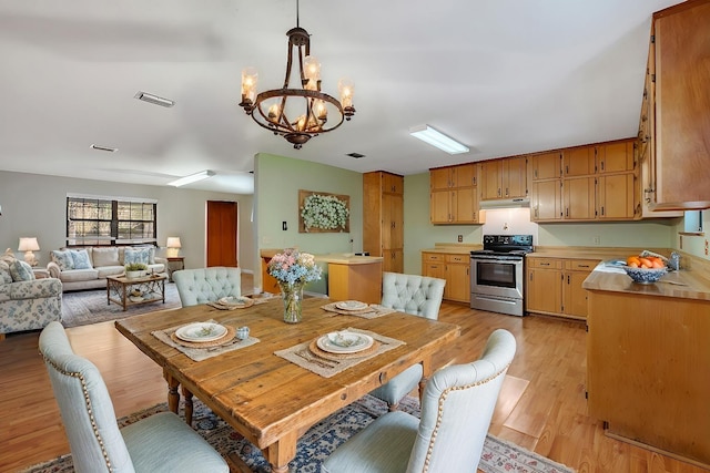 dining space featuring a chandelier and light hardwood / wood-style flooring