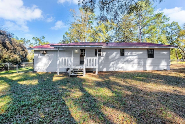 rear view of property featuring a yard