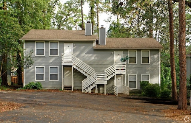 view of front of home with stairway and a chimney