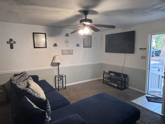 living area featuring a ceiling fan, carpet floors, and baseboards