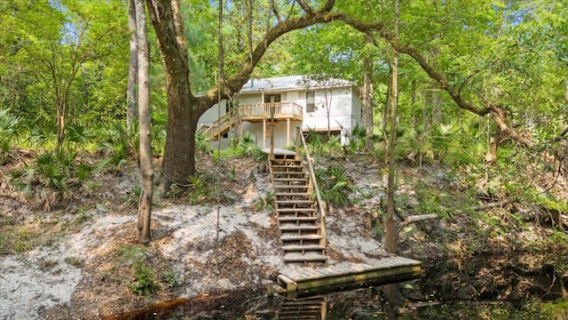 rear view of house featuring a deck