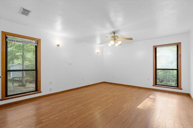 spare room featuring light hardwood / wood-style flooring and ceiling fan