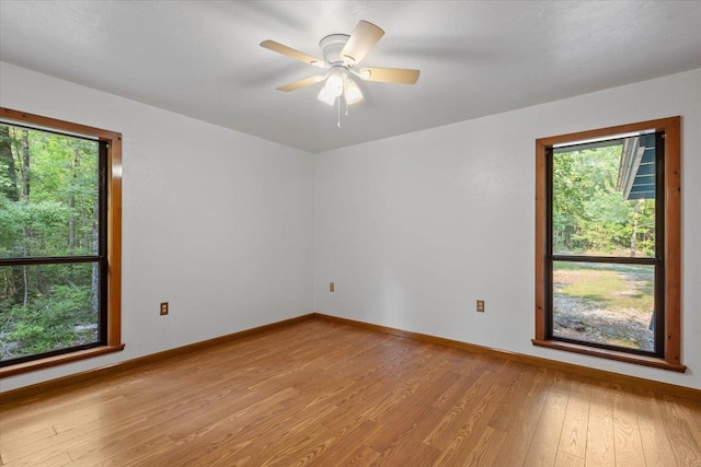 spare room featuring ceiling fan and light hardwood / wood-style floors