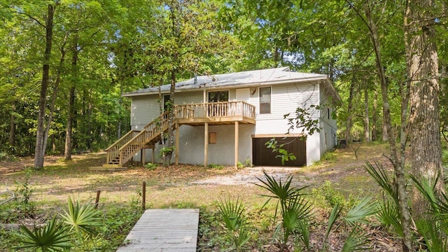 back of house featuring a wooden deck