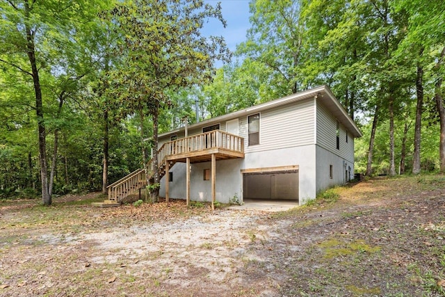 view of front facade with a garage and a wooden deck