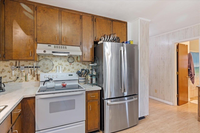 kitchen with light hardwood / wood-style floors, white range with electric cooktop, and stainless steel refrigerator