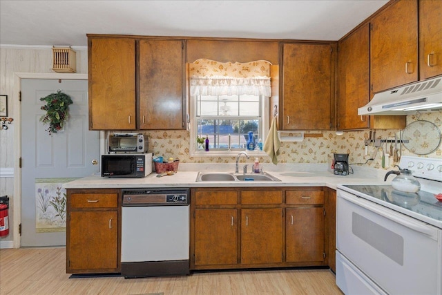 kitchen with backsplash, sink, white appliances, and light wood-type flooring