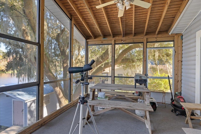 unfurnished sunroom featuring ceiling fan, lofted ceiling, and wood ceiling