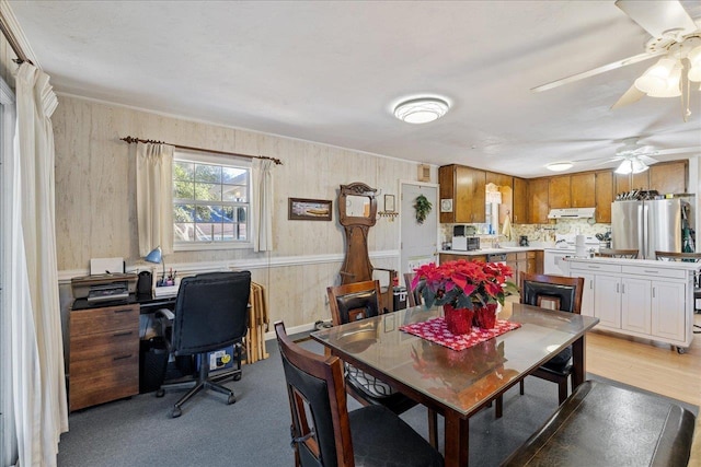 carpeted dining space with sink