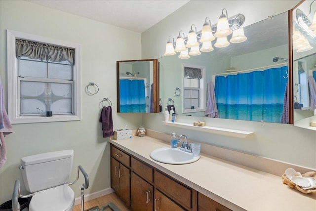 bathroom with a shower with shower curtain, vanity, and toilet