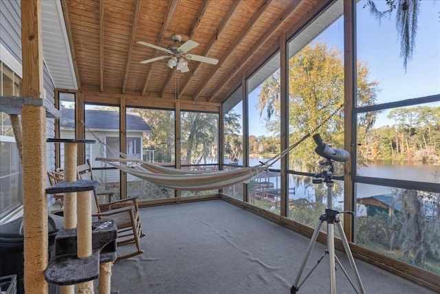 unfurnished sunroom with ceiling fan, lofted ceiling with beams, a water view, and wooden ceiling