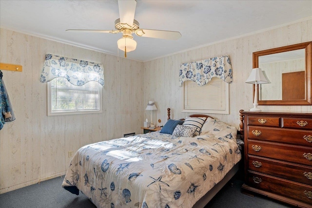 carpeted bedroom featuring ceiling fan and crown molding