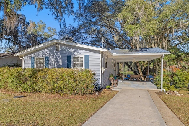 view of side of property featuring a yard and a carport