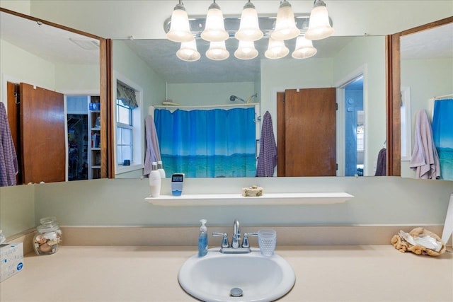 bathroom with walk in shower and sink