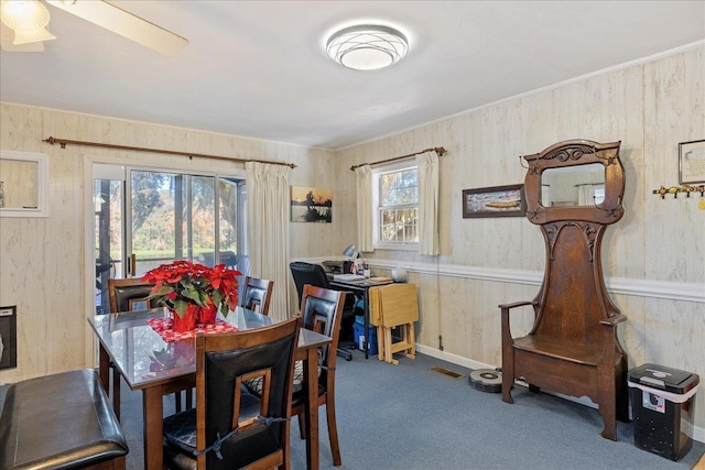 carpeted dining space with a healthy amount of sunlight