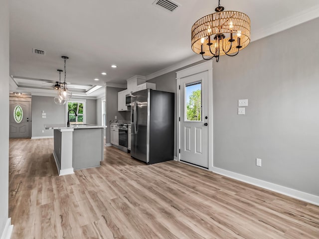 1613 Sea Breeze Way, Carrabelle, FL 32322 - kitchen with ornamental molding, stainless steel appliances, gray cabinetry, and light stone counters