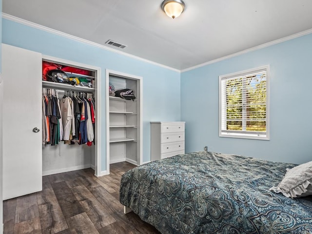 bedroom featuring crown molding, a closet, and dark wood-type flooring